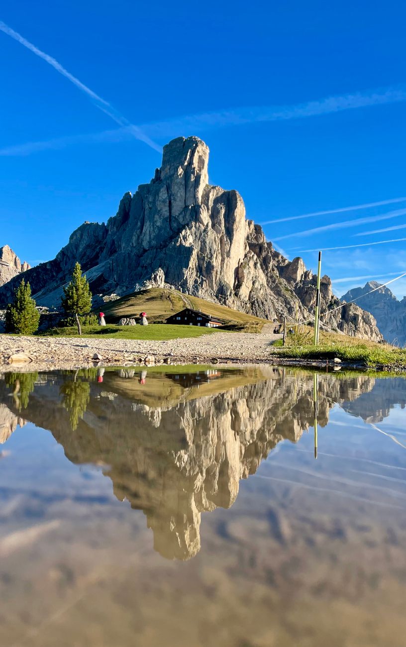 Dolomites sunrise reflection in alpine tarn